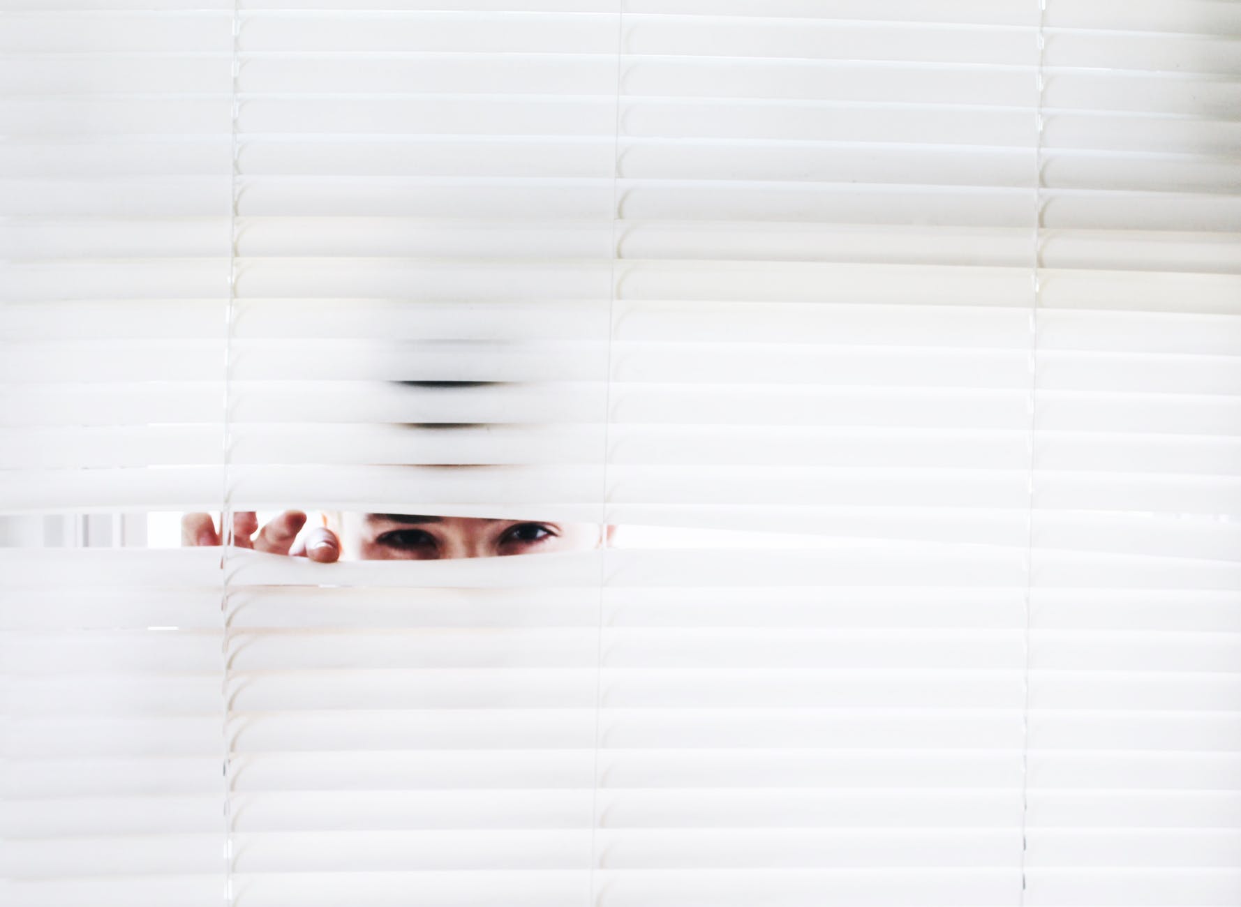 photography of person peeking window