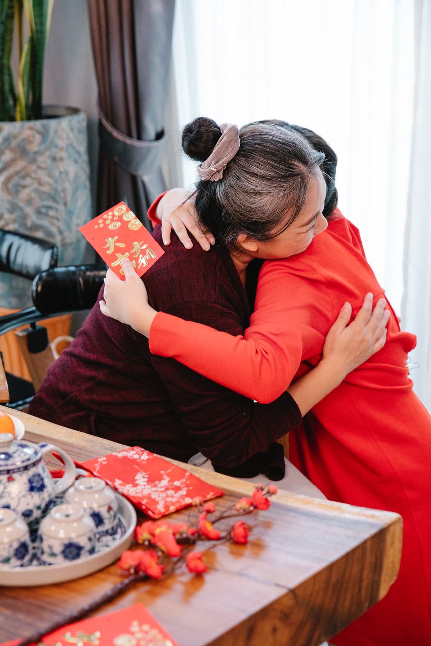 granddaughter embracing asian grandma during Chinese new year holiday